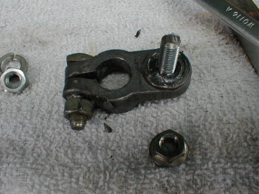 View showing new bolt with embedded nut and terminal clamp nut below.