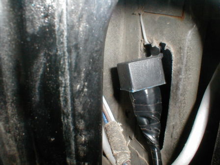 View of relay zip tied inside area behind rear driver side lense.