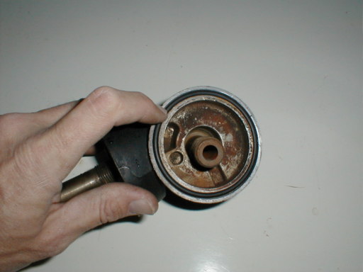 Largest o-ring goes on bottom of oil filter mount and is sandwiched between the block & the mount. Use a dab of axle grease to hold it in place.