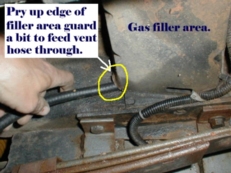 Routed hose behind front tank hanger bolts, then beside skid & up into gas filler area.