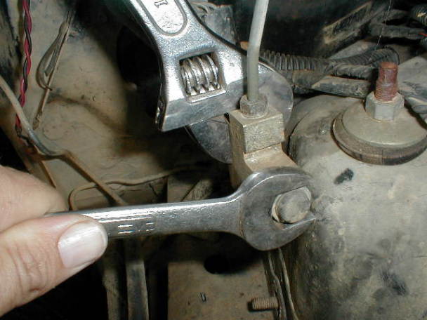 3/4" open end wrench and crescent wrench used to remove front fitting and keep valve from twisting and damaging lines.